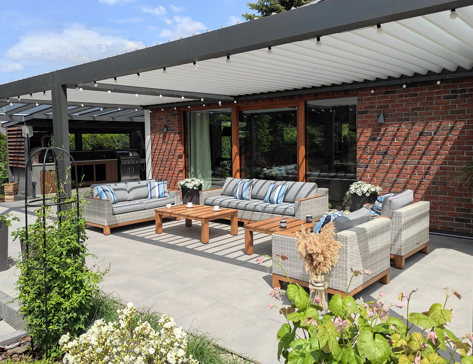 Zestaw PALERMO PREMIUM na tarasie z ogrodem w tle — letnia aranżacja, pergola bioklimatyczna
